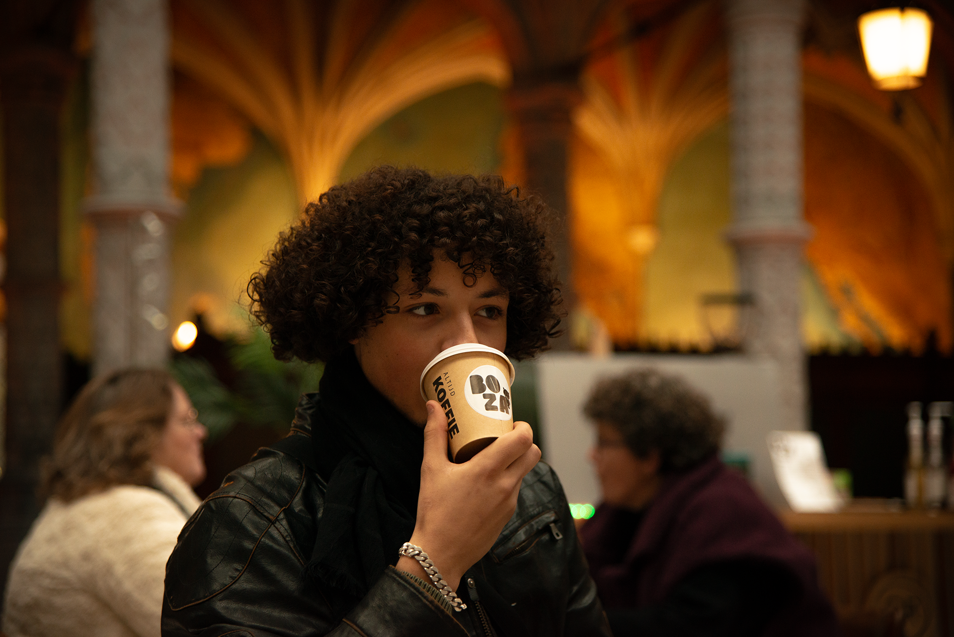 Customers enjoying specialty coffee at Boza Café inside the historic Handelbeurs Antwerp